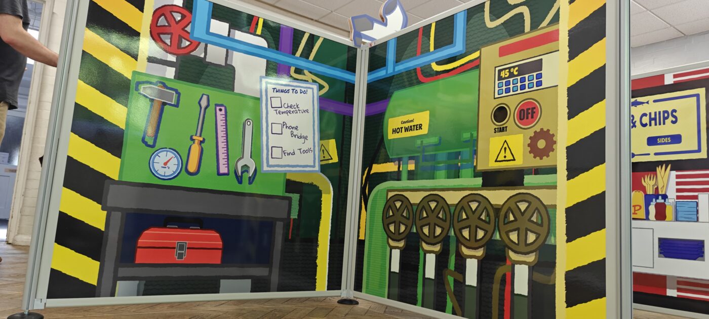 Complete flat-pack role-play village installation featuring freestanding scenic panels and interactive props ready for play onboard P&O Cruises.