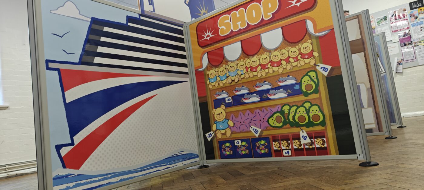 Complete flat-pack role-play village installation featuring freestanding scenic panels and interactive props ready for play onboard P&O Cruises.