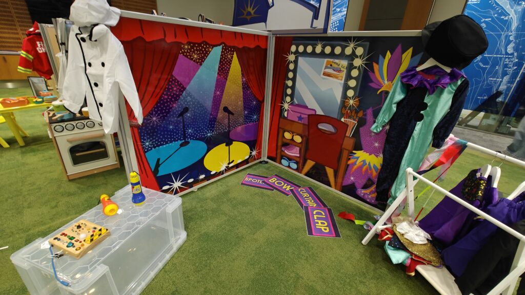 Complete flat-pack role-play village installation featuring freestanding scenic panels and interactive props ready for play onboard P&O Cruises.