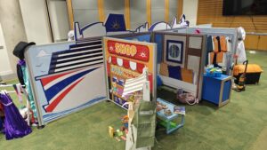 Complete flat-pack role-play village installation featuring freestanding scenic panels and interactive props ready for play onboard P&O Cruises.